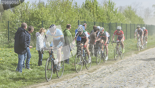 Image of The Peloton on a Cobblestoned Road