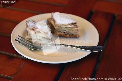 Image of Two pieces of baklava on the plate with a fork