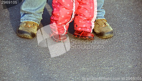 Image of man and baby girl legs 