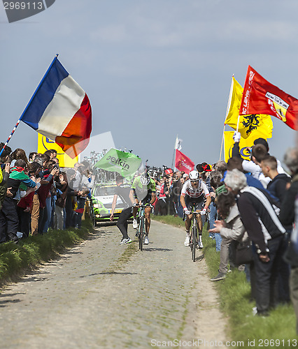 Image of Two Cyclists on a Cobblestoned Road