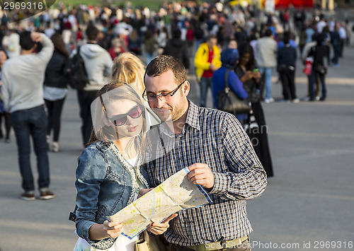 Image of Couple with a Map in a Crowded City