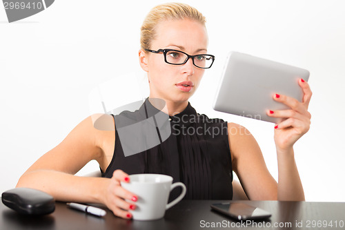 Image of Business woman working on tablet PC.