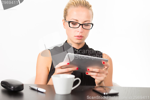 Image of Business woman working on tablet PC.