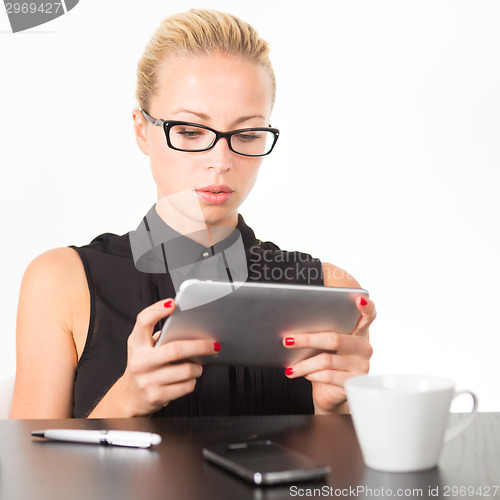 Image of Business woman working on tablet PC.