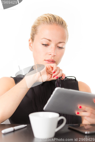 Image of Business woman working on tablet PC.