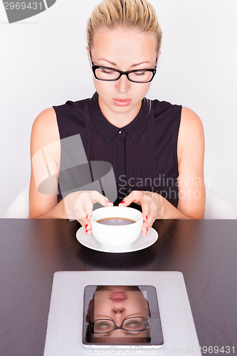 Image of Business woman with cup of coffee.