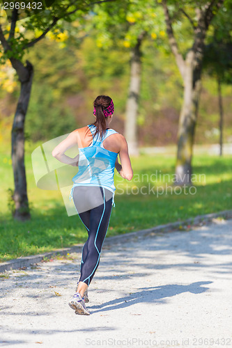 Image of Young girl runner on the street.