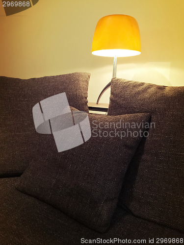 Image of Cozy orange lamp and comfortable sofa