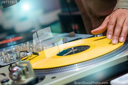 Image of DJ playing vinyl on turntable