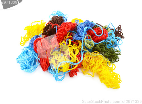 Image of Multi-coloured embroidery threads in a tangled heap