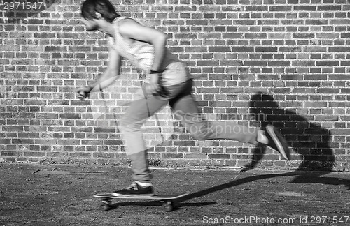 Image of Skateboarder at speed through the city