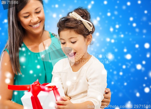 Image of happy mother and little girl with gift box