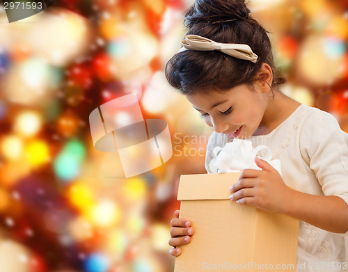 Image of smiling little girl with gift box