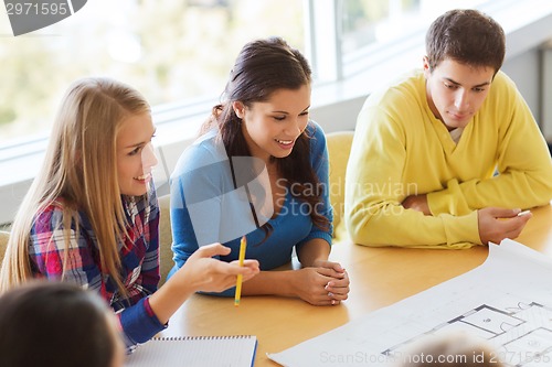 Image of group of smiling students with blueprint