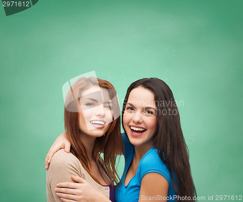 Image of smiling teenage girls hugging