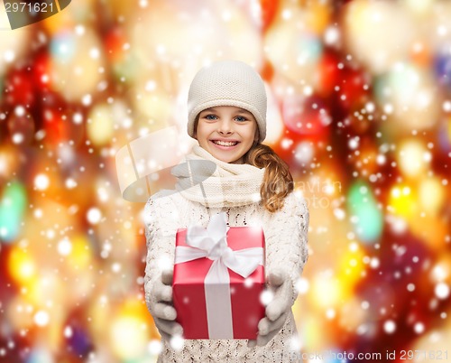 Image of girl in hat, muffler and gloves with gift box