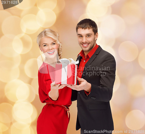 Image of smiling man and woman with present