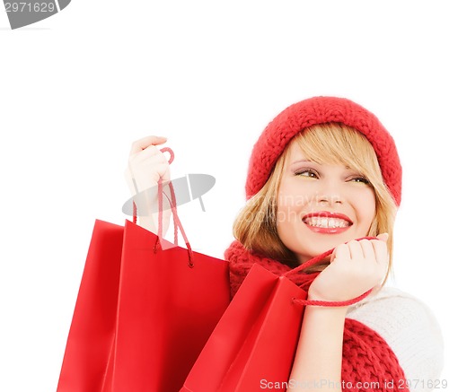Image of smiling young woman with shopping bags