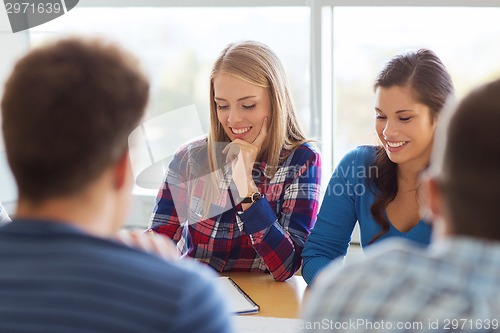 Image of group of smiling students with blueprint