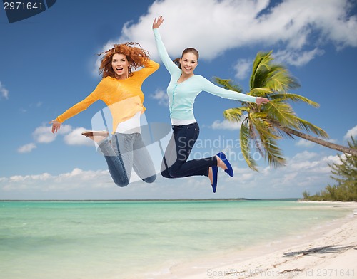 Image of smiling young women jumping in air