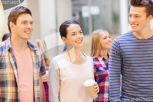 Image of group of smiling students with paper coffee cups