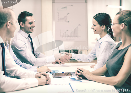 Image of businessman and businesswoman shaking hands