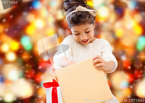 Image of smiling little girl with gift box