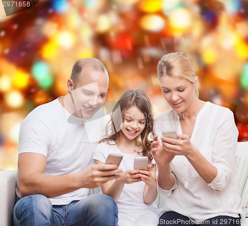 Image of happy family with smartphones