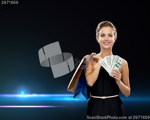 Image of smiling woman in dress with shopping bags