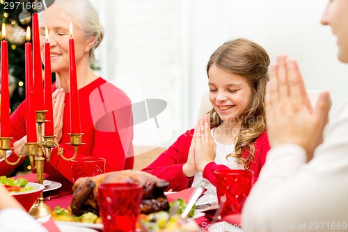 Image of smiling family having holiday dinner at home