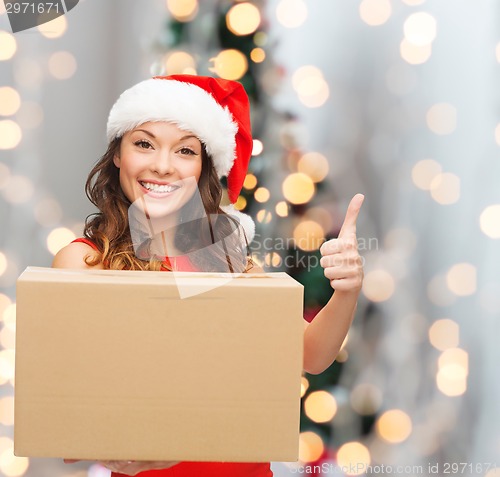 Image of smiling woman in santa helper hat with parcel box