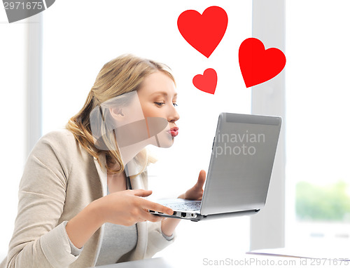 Image of woman sending kisses with laptop computer