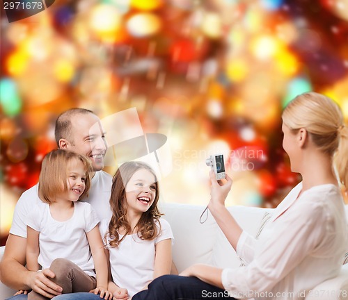 Image of happy family with camera at home