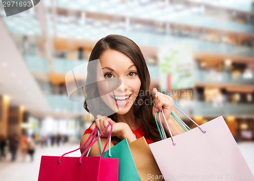 Image of smiling woman with colorful shopping bags