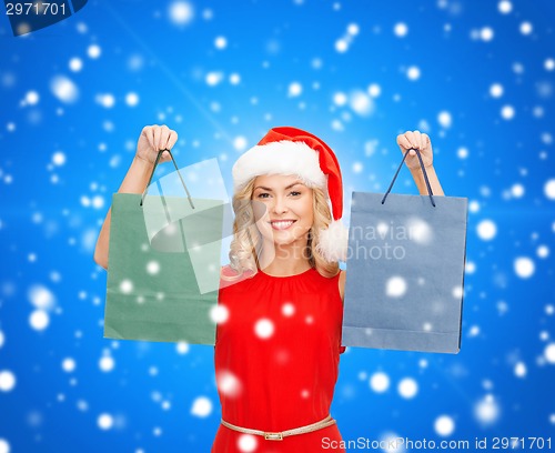 Image of woman in santa helper hat with shopping bags