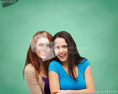 Image of smiling teenage girls hugging