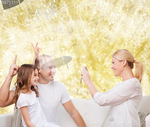 Image of happy family with camera at home