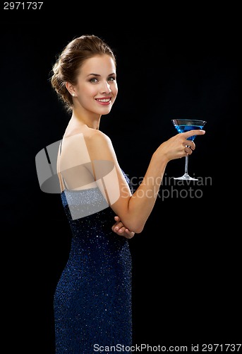 Image of smiling woman holding cocktail