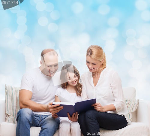 Image of happy family with book at home
