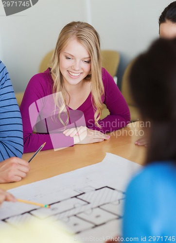 Image of group of smiling students with blueprint