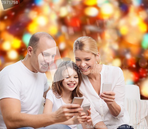Image of happy family with smartphones