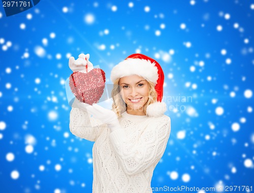 Image of smiling woman in santa helper hat with red heart