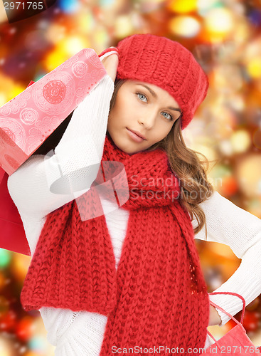 Image of smiling young woman with shopping bags