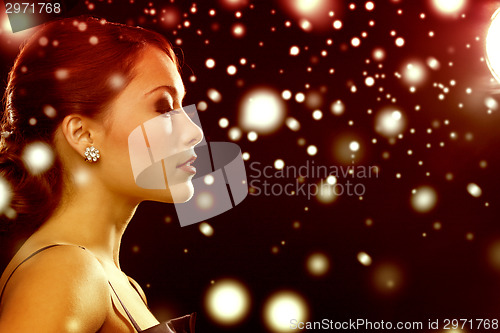 Image of woman in evening dress wearing diamond earrings