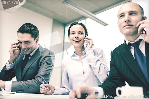 Image of business team with smartphones having conversation