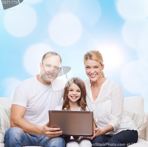 Image of smiling family with laptop