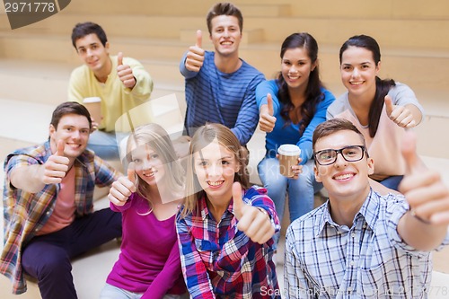 Image of group of smiling students with paper coffee cups