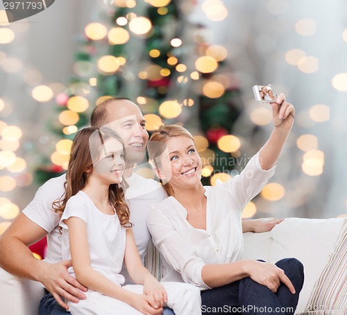 Image of happy family with camera at home