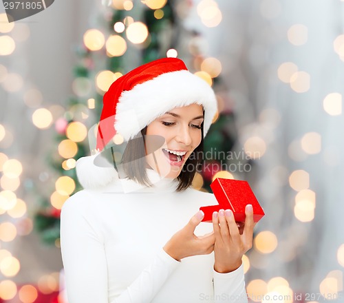 Image of smiling woman in santa helper hat with gift box