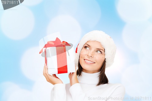 Image of smiling woman in santa helper hat with gift box